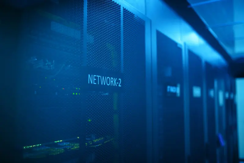 Network racks in a blue-lit data centre